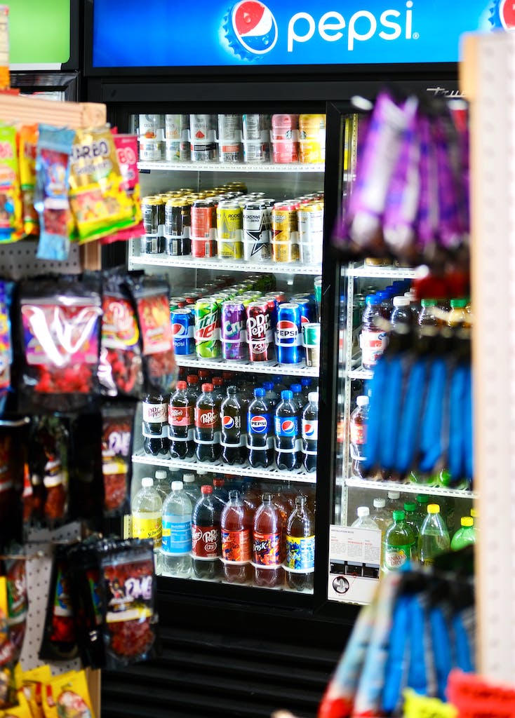 Refreshingly stocked fridge with an assortment of soft drinks and tempting confectionery delights for every taste bud.